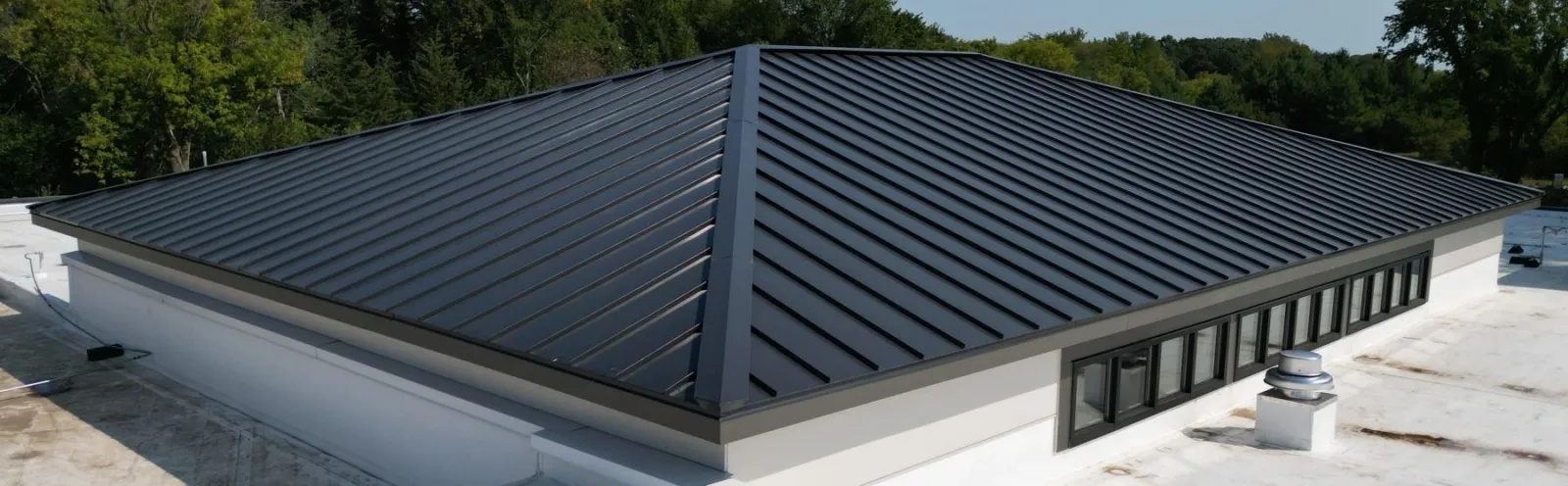 Close detail of a charcoal standing-seam metal roof